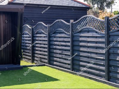 stock-photo-black-wooden-garden-fence-with-a-fancy-trellis-2317646333