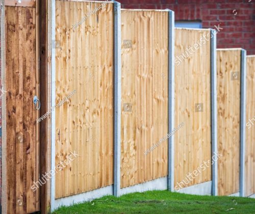 stock-photo-new-built-wooden-boarded-fence-background-in-english-town-uk-2441898619